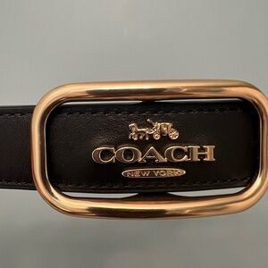 Coach black leather belt with brass buckle.